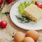 Close up omelet with ham on parchment background. Vegetable composition.