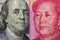 Close up of one hundred Dollar and 100 Yaun banknotes with focus on portraits of Benjamin Franklin and Mao Tse-tung/USA vs China t