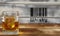 Close up of one isolated whisky glass with ice cube and timber wood planks background, fictional barcode focus on glass