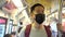 Close up of one young Asian man wearing a black surgical face mask in subway train during new type Coronavirus Covid-19