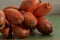 Close-up of onions. Shallots tied in bunches on a green wooden table. Shallow depth of field. Art image of a shallot.