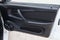 Close-up of the open front door of a Russian LADA vaz 2114 car with a new factory-made music speaker on a black plastic panel,