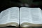 Close up of open Holy Bible in Psalm 121. Blurred background.