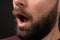 close-up of open mouth of bearded young man feeling surprise, shock, excitement. Concept of expressions of emotions and