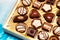 Close up of open small gift box of Swiss chocolate candies. Luxurious selection of milk, dark and white miniature