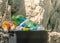 Close-up open Trash can overflowing with empty plastic bottles in the mountains. The problem of environmental pollution.