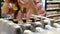 Close-up of an opened pack of beer bottles in alcohol department and a buyer takes two of them