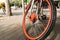 Close up the orange bicycle wheel and tire