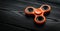 close up orange spinner on a black background