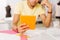 Close up of orange tablet in the hands of young man