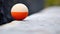 A close up of an orange and white egg sitting on a ledge, AI