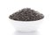 Close-up of Organic Black Gram Vigna mungo or whole black urad inside a ceramic white bowl.