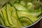 Close up of organic cucmber salad in a stainless steel serving bowl