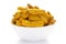 Close-up of Organic dry turmeric root Curcuma longa on a ceramic white bowl. Pile of Indian Aromatic Spice