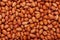 Close-up of organic red-brown peanuts Arachis hypogaea Full Frame Background.