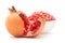 Close-up of organic red pomegranate and a section of it  Punica granatum  with a bowl seed pods of pomegranate   isolated over