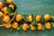 Close up of organically grown apricots. Basket full of apricots on green wooden background