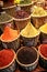 A close-up of oriental spices poured into wicker baskets