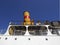 Close-up of Original Funnel or Yellow and Red Merchant Ship Chimney, under intense blue sky. Side view of deck and chimney of