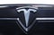 Close-up of original Tesla car logo on front side