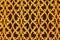 Close-up of an ornate forged gold-covered grid of air duct in arabic style vent. Oriental flower pattern of vent grille