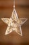 A close up of an ornate star shaped Christmas tree decoration