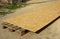 A close-up of OSB, oriented strand board, plywood sheet on the construction site as a roof sheathing material