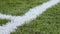 Close up of the out of bounds line on a turf
