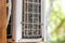 Close-up outdoor air condition unit with clogged obstructed compressor radiator grill. Details of air conditioner needed