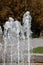 Close up outdoor view in the night of a public fountain with many small water jets. Abstract natural image with pattern