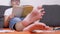 Close-up of Outstretched Legs a Tired Schoolboy Reading a Book on Floor in Room