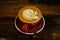 Close up overhead view of a cup of strong frothy coffee .