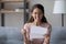 Close up overjoyed laughing woman wearing glasses reading letter