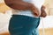 Close Up Of Overweight Woman Measuring Waist