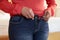 Close Up Of Overweight Woman Trying To Fasten Trousers