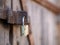 Close up of a padlock securing a rusty and weathered wooden door