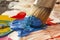 Close up of paintbrush picking blue color from an artist palette. Colorful image from an artistâ€™s studio or a school showing cre