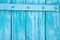 Close up of painted wooden gate in turquoise