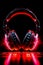Close up of pair of headphones on black background with red light