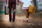 Close-up of a pair of newlyweds walking with suitcases