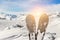 Close-up pair of skis on mountain winter resort with ski-lift and beautiful winter mountain panoramic scenic view