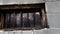 Close up pan of a spooky old concrete block jail with bars in windows