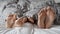 Close-up of parents and their child\'s feet snuggled up together under a soft and warm blanket. Concept of family relaxation.