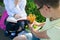 Close-up, in the park, in the fresh air, schoolchildren doing homework, a boy holding a glass with pencils