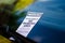 Close-up of parking ticket on car`s windshield