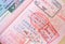 close up part of pages of foreign passport with foreign visas, border stamps, china permits to enter countries, concept of