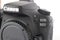 Close up partial front view of Canon EOS 90D camera body.