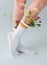 close-up partial view of girl in socks with beautiful fresh flowers