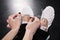 Close-up partial view of woman dancer tying ballet shoes