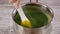 Close-up. Pastry chef stirring kiwi puree to make jelly.